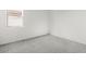 A carpeted bedroom has white walls and a window for natural light at 18174 W Pima St, Goodyear, AZ 85338