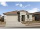 Charming single-story home featuring a two-car garage, concrete driveway, and well-manicured front yard at 18174 W Pima St, Goodyear, AZ 85338