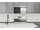 The gourmet kitchen features modern appliances, ample cabinet space and white countertops at 18174 W Pima St, Goodyear, AZ 85338