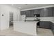 Spacious kitchen boasts an island, modern appliances, ample counter space, and lots of cabinets at 18174 W Pima St, Goodyear, AZ 85338