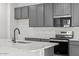 The gourmet kitchen features modern appliances, ample cabinet space and white countertops at 18174 W Pima St, Goodyear, AZ 85338
