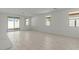 Large, open living room with tiled floors and plenty of natural light at 18174 W Pima St, Goodyear, AZ 85338