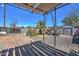 Backyard featuring a wooden pergola, gravel, and various yard objects at 2124 W Maricopa St, Phoenix, AZ 85009