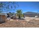 Large backyard area with dirt and gravel surfaces, a palm tree, and some debris at 2124 W Maricopa St, Phoenix, AZ 85009