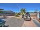 Spacious backyard showcasing a mix of gravel and brick, bordered by fencing at 2124 W Maricopa St, Phoenix, AZ 85009