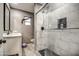 Modern bathroom with updated marble-look tile and a glass-enclosed shower at 2124 W Maricopa St, Phoenix, AZ 85009