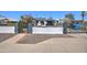 Street view of home with block fence, wrought iron gate, and decorative shrubbery at 2124 W Maricopa St, Phoenix, AZ 85009