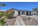 Charming home featuring a stone pathway leading to an arched front porch at 2124 W Maricopa St, Phoenix, AZ 85009