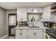 Well-lit kitchen with white cabinets, subway tile backsplash, and stainless steel appliances at 2124 W Maricopa St, Phoenix, AZ 85009