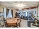 Cozy living room featuring wood floors, a chandelier, and a dark, luxurious leather sofa at 2124 W Maricopa St, Phoenix, AZ 85009