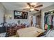Comfortable bedroom featuring a ceiling fan, a spacious closet, and a TV at 2124 W Maricopa St, Phoenix, AZ 85009
