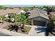 Aerial view of a well-maintained home with a 2-car garage, desert landscaping, and solar panels at 13055 W Eagle Talon Trl, Peoria, AZ 85383