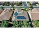 Stunning aerial view of a home featuring solar panels on the roof, nestled in a well-maintained community with lush landscaping at 13055 W Eagle Talon Trl, Peoria, AZ 85383