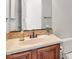 Bathroom features a vanity with a sink, decorative mirror, and framed cabinets at 13055 W Eagle Talon Trl, Peoria, AZ 85383