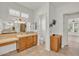 Spacious bathroom with double vanity, a walk-in shower, and a mounted TV for convenience at 13055 W Eagle Talon Trl, Peoria, AZ 85383