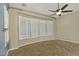 Bright bedroom with a curved window wall and plantation shutters at 13055 W Eagle Talon Trl, Peoria, AZ 85383