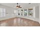 Bright bedroom with tile flooring, a ceiling fan, plantation shutters, and multiple windows for ample light at 13055 W Eagle Talon Trl, Peoria, AZ 85383