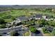 An aerial view of the clubhouse situated on a well-manicured golf course with surrounding neighborhood at 13055 W Eagle Talon Trl, Peoria, AZ 85383