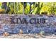 Stone sign for the Kiva Club community, surrounded by desert landscaping and lush greenery at 13055 W Eagle Talon Trl, Peoria, AZ 85383