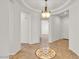 Grand foyer with elegant tile flooring and a decorative ceiling light at 13055 W Eagle Talon Trl, Peoria, AZ 85383