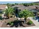 Charming single-story home with desert landscaping, mature palm trees, and a stone-accented facade at 13055 W Eagle Talon Trl, Peoria, AZ 85383