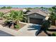 Inviting home with lush landscaping, a spacious driveway, and an attached two-car garage at 13055 W Eagle Talon Trl, Peoria, AZ 85383