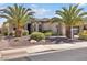 Beautiful home with lush desert landscaping, palm trees, and a tile roof at 13055 W Eagle Talon Trl, Peoria, AZ 85383
