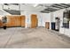 An organized garage with overhead storage, cabinets, and shelving at 13055 W Eagle Talon Trl, Peoria, AZ 85383