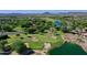 Great aerial view of a golf course, water hazard and surrounding properties at 13055 W Eagle Talon Trl, Peoria, AZ 85383