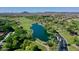 Beautiful aerial view of golf course, a serene lake, and lush landscaping at 13055 W Eagle Talon Trl, Peoria, AZ 85383