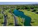 A beautiful overhead shot of a well-maintained golf course with mature landscaping and a lake at 13055 W Eagle Talon Trl, Peoria, AZ 85383
