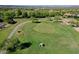 Aerial view of the lush green golf course featuring manicured fairways and mature trees at 13055 W Eagle Talon Trl, Peoria, AZ 85383