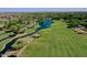 Overhead view of the golf course with water features that are surrounded by lush greenery and mature trees at 13055 W Eagle Talon Trl, Peoria, AZ 85383