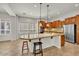 Kitchen featuring a large island, stainless steel appliances, and warm wood cabinetry at 13055 W Eagle Talon Trl, Peoria, AZ 85383