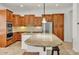 Spacious kitchen with wood cabinets, granite countertops, stainless steel appliances, and eat-in bar seating at 13055 W Eagle Talon Trl, Peoria, AZ 85383