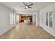 Bright and airy living room featuring a tile floor, neutral walls, and access to the kitchen at 13055 W Eagle Talon Trl, Peoria, AZ 85383