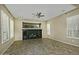 Spacious living room with tile floors and large windows with plantation shutters at 13055 W Eagle Talon Trl, Peoria, AZ 85383