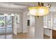 Open living space featuring a decorative pendant light and seamless flow to the patio at 13055 W Eagle Talon Trl, Peoria, AZ 85383