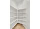 Walk-in pantry with ample shelving for organized storage solutions, tiled floor, and clean white walls at 13055 W Eagle Talon Trl, Peoria, AZ 85383
