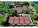 Aerial view of tennis and pickleball courts with beautiful landscaping, a shaded area, and well-maintained grounds at 13055 W Eagle Talon Trl, Peoria, AZ 85383