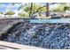 Close-up of a stone waterfall feature adding natural beauty to the community's landscape at 13055 W Eagle Talon Trl, Peoria, AZ 85383