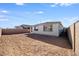 Exterior view of the home with a spacious dirt backyard at 16766 W Yucatan Dr, Surprise, AZ 85388