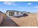 Exterior view of the home with a spacious dirt backyard at 16766 W Yucatan Dr, Surprise, AZ 85388