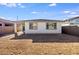 Exterior view of the home with a spacious dirt backyard at 16766 W Yucatan Dr, Surprise, AZ 85388