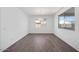 Open dining room with wood-look tile flooring, a modern chandelier, and a view of the backyard at 16766 W Yucatan Dr, Surprise, AZ 85388