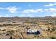 Aerial view showcasing a modern house, expansive lot, and distant mountain range at 31559 N Pamela Dr, Queen Creek, AZ 85144