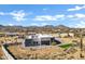 Aerial view of a modern house with desert landscaping and mountain views at 31559 N Pamela Dr, Queen Creek, AZ 85144