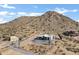 Aerial view of a house with mountain backdrop at 31559 N Pamela Dr, Queen Creek, AZ 85144