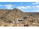 Aerial view of a house on a hilltop lot with mountain and desert landscape at 31559 N Pamela Dr, Queen Creek, AZ 85144