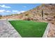 Artificial turf backyard with flagstone patio at 31559 N Pamela Dr, Queen Creek, AZ 85144